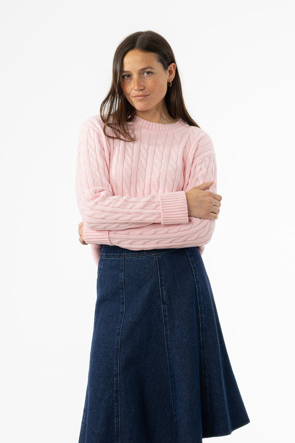 Soft pink cable knit sweater with round neckline