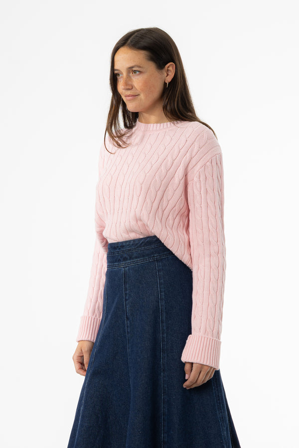 Soft pink cable knit sweater with round neckline
