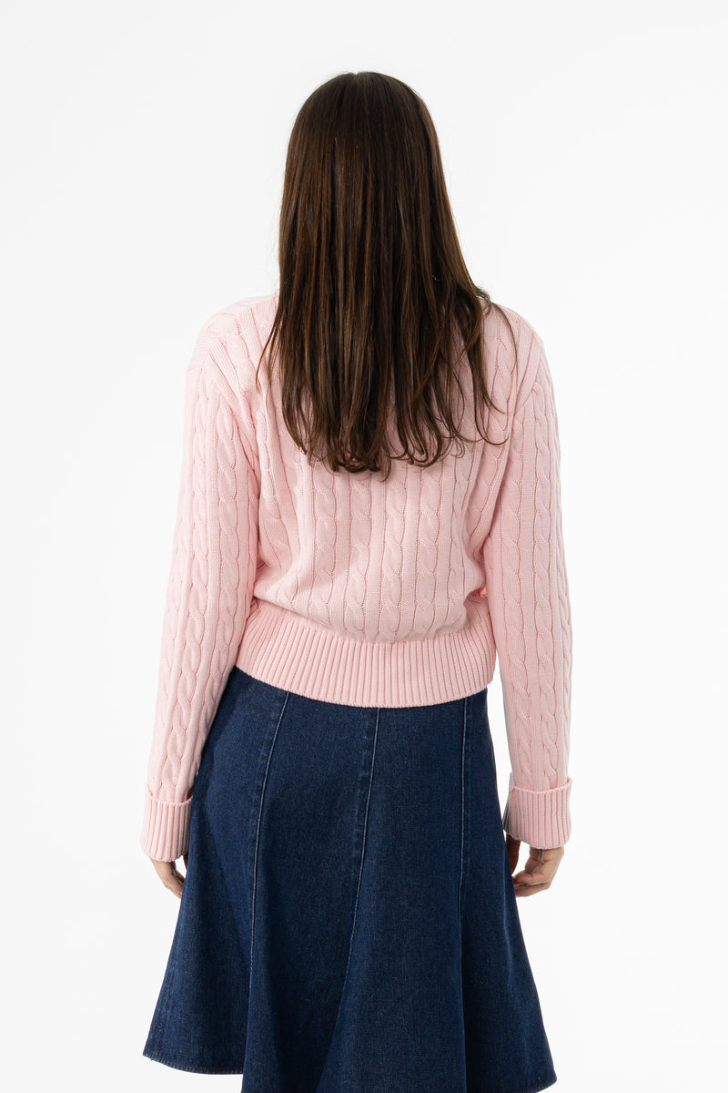 Soft pink cable knit sweater with round neckline
